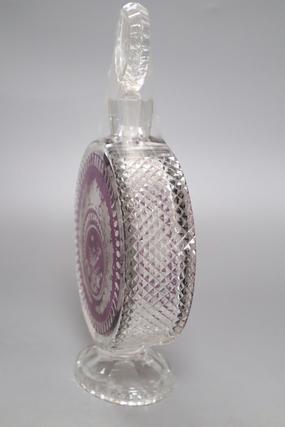 An amethyst overlaid cut glass decanter, height 27cm (a.f.)